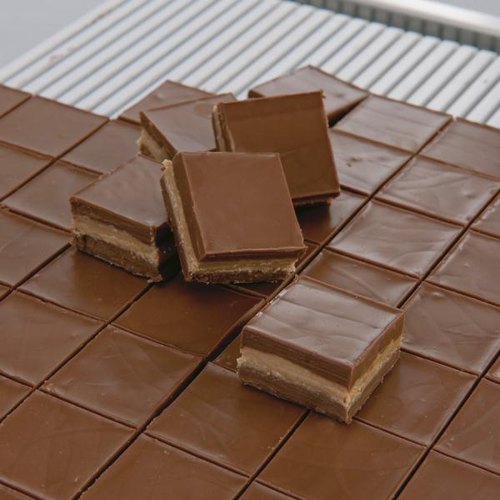 Precise 1" squares of 3 layered ganache cut on guitar cutter 